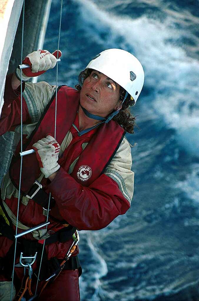 Madeleine Habib climbing on the side of the MV Greenpeace. Greenpeace activist Madeleine Habib, exercising climbing skills on board the MV Greenpeace, during forest actions in Europe, July 2000.